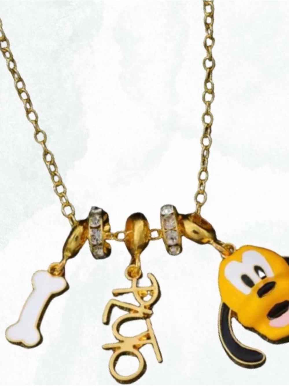 Gold Plated Yellow Pluto Charm Necklace with Bone and 'Auro' Script